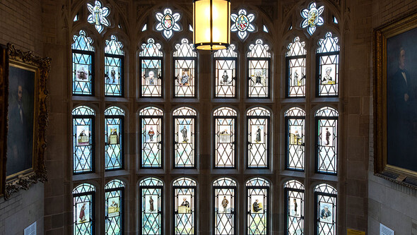 A row of stained glass windows in the main stairwell